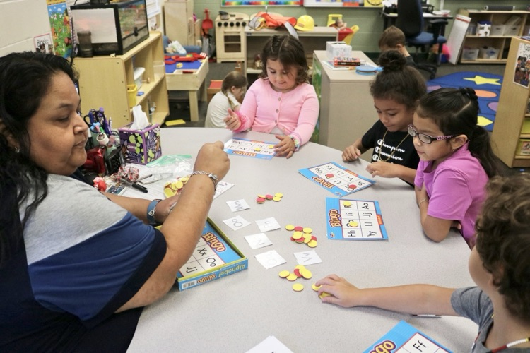 group of students playing abc bingo with teacher 