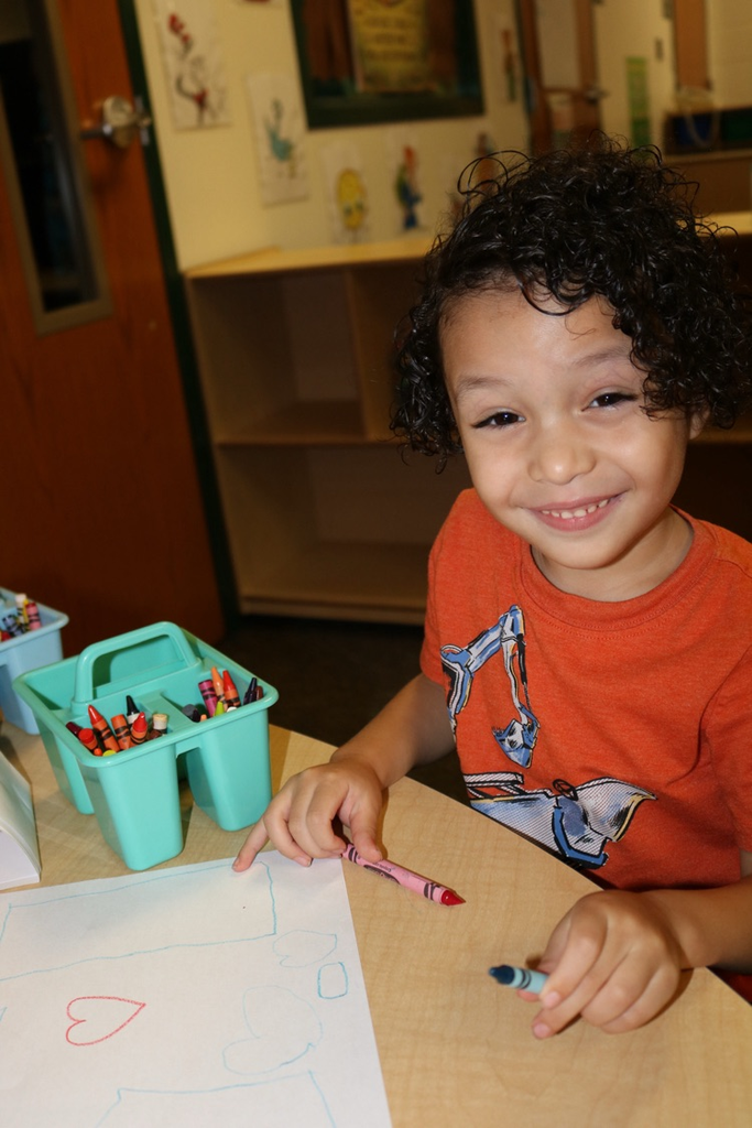 student drawing in prek class