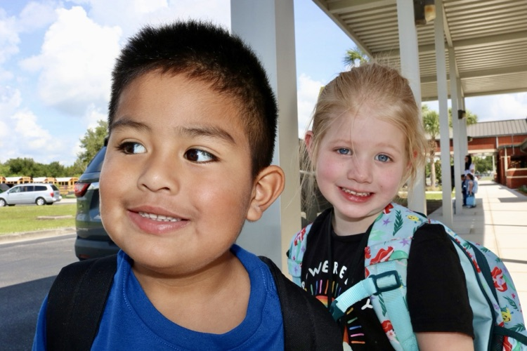 two students waiting at dismissal