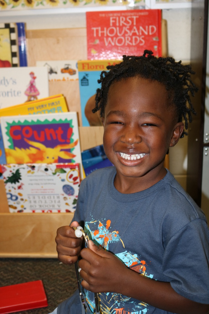 student smiling by books