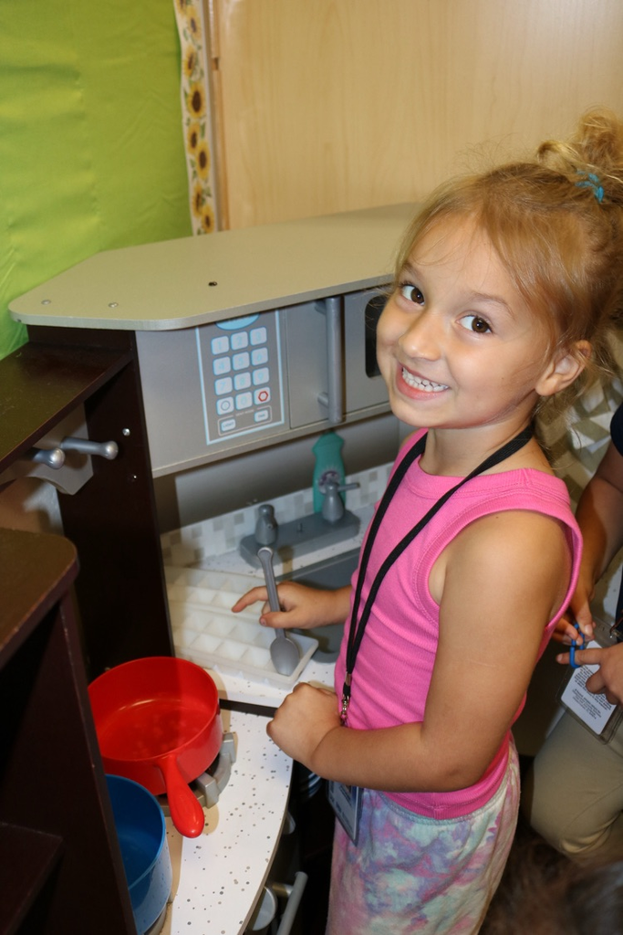 student playing kitchen 