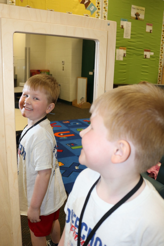 student smiling at mirror