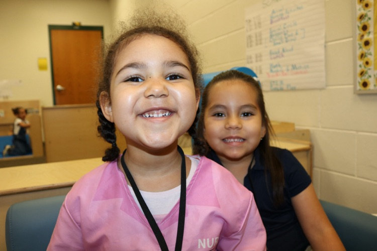 two students smiling in prek class couch