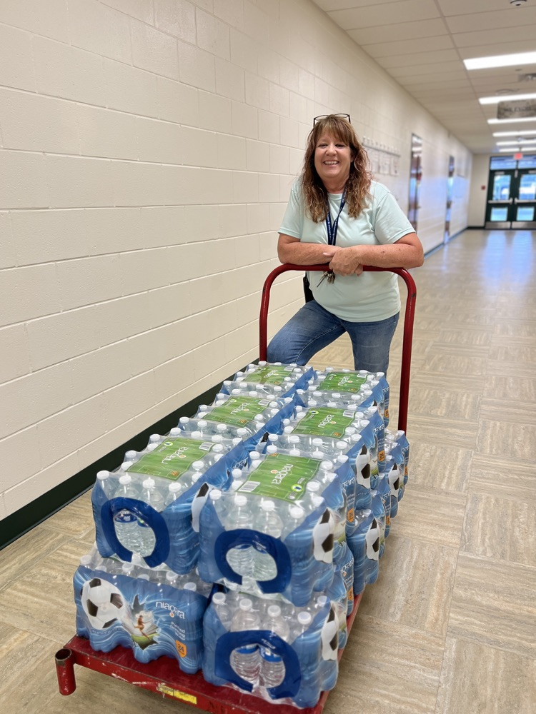 custodian distributing water bottles 