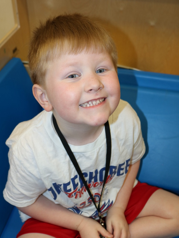 little boy smiling in class