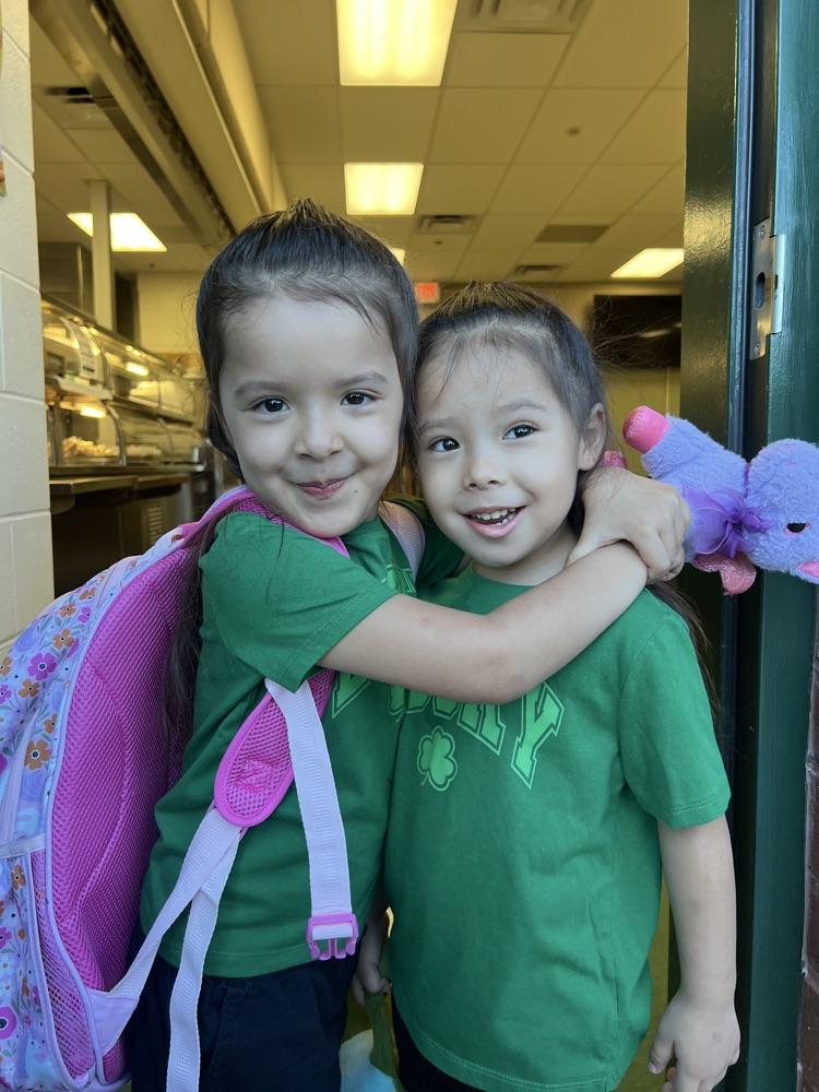 two girls wearing green for spirit day