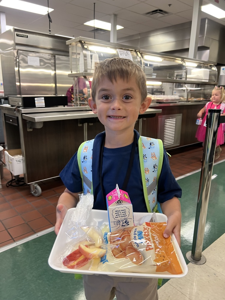 student wearing blue for spirit day in cafeteria 
