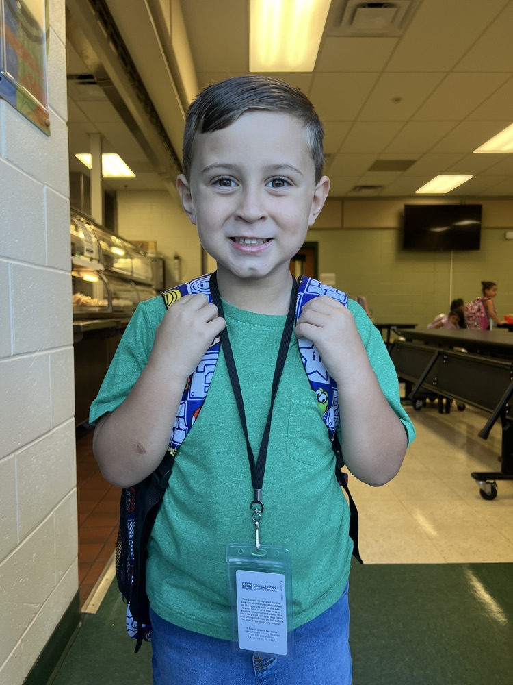 student wearing green for spirit day in cafeteria 