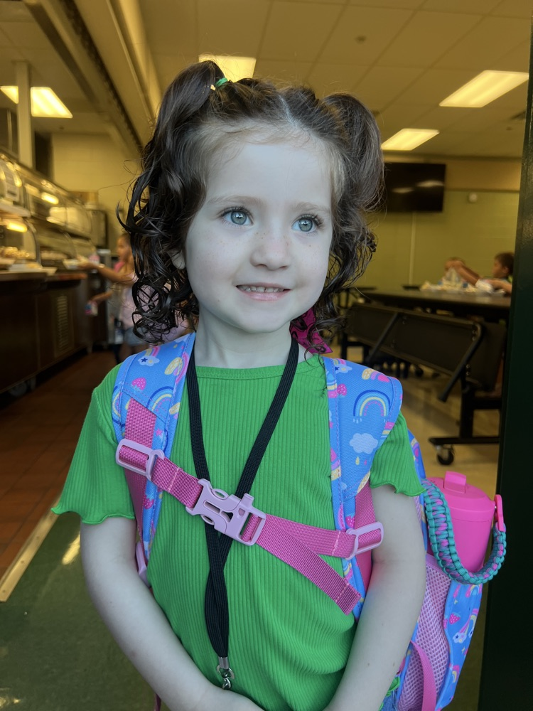 student wearing green for spirit in cafeteria 