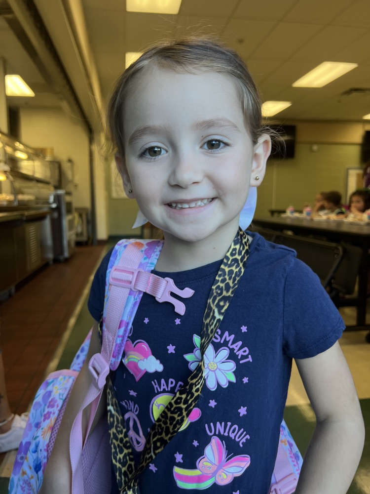student wearing blue for spirit day in cafeteria 