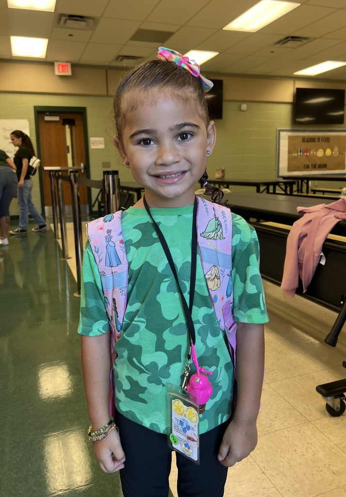 student wearing green for spirit day in cafeteria 