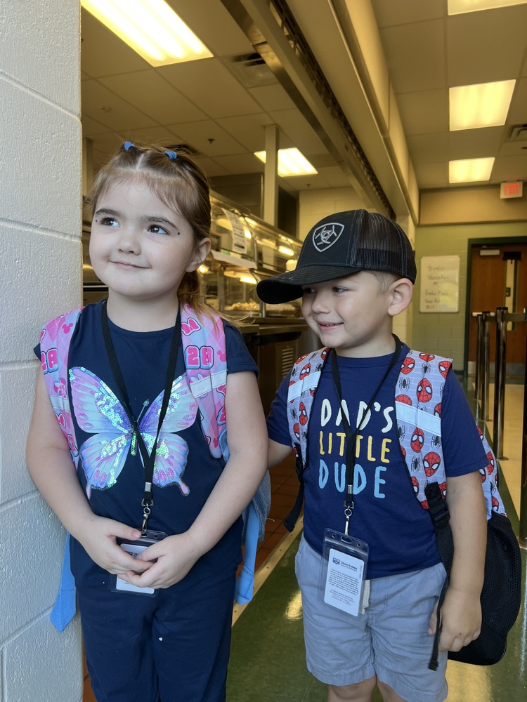 two students wearing blue for spirit day in cafeteria 