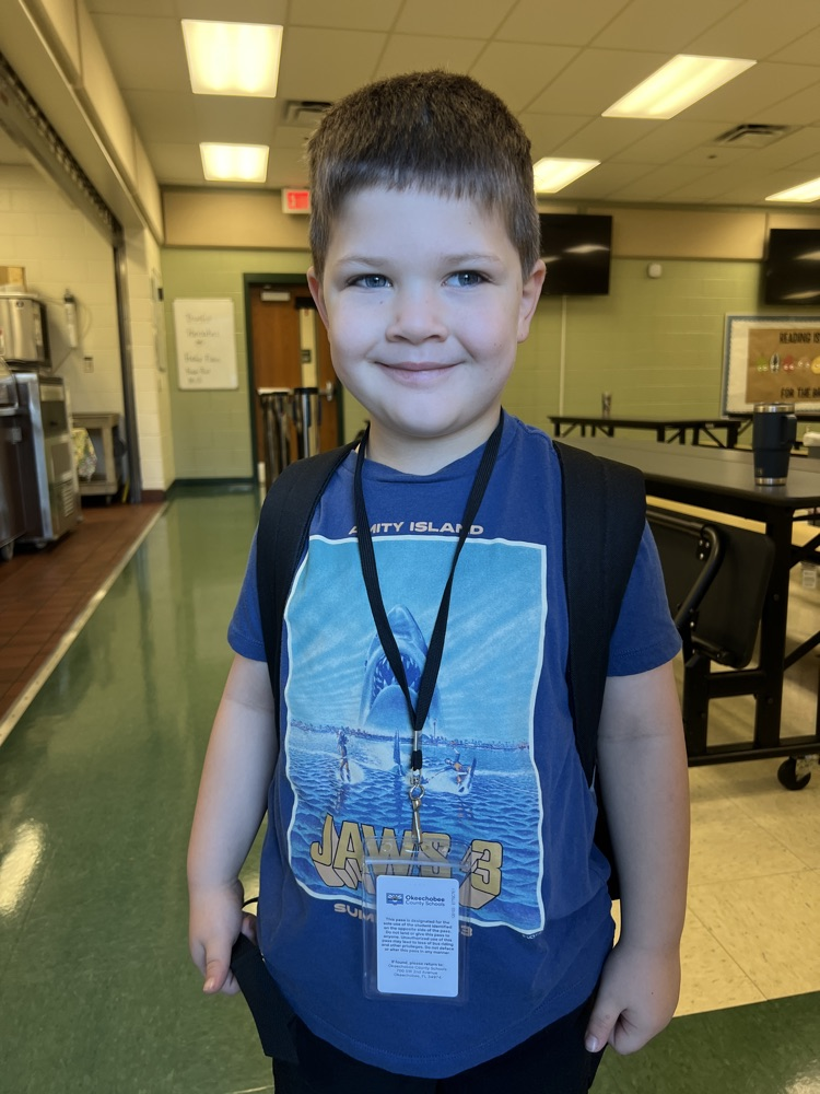 student wearing blue for spirit day in cafeteria 