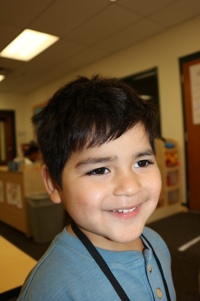 one prek student smiling 