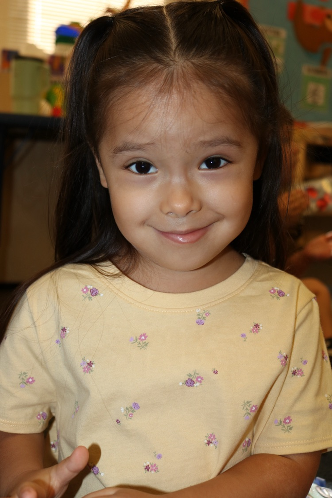 one prek girl smiling