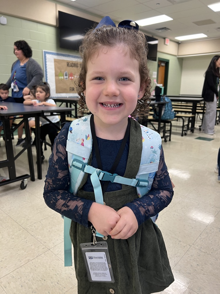 student wearing blue and green in cafeteria