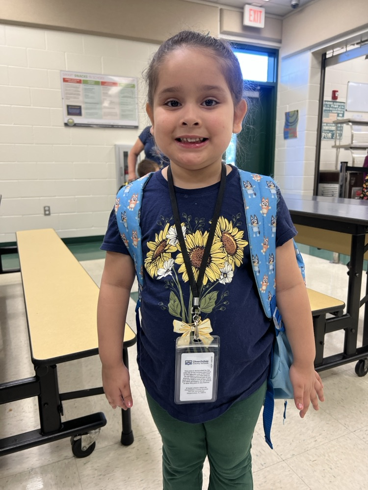student wearing blue and green in cafeteria