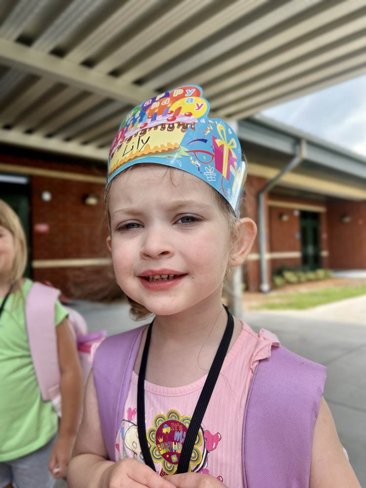 prek student with birthday crown at dismissal