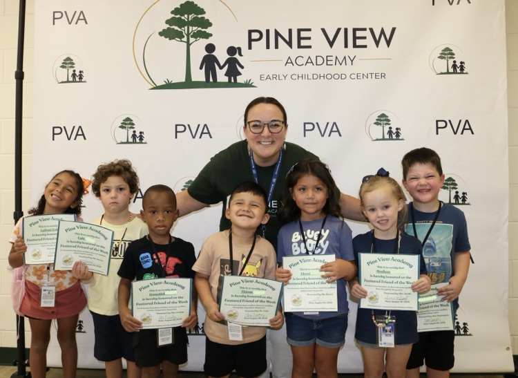 principal with 7 students infront of PVA backdrop