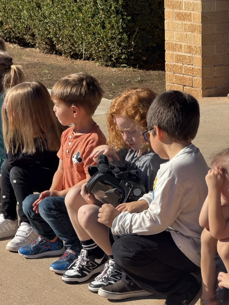 kids looking at helmet