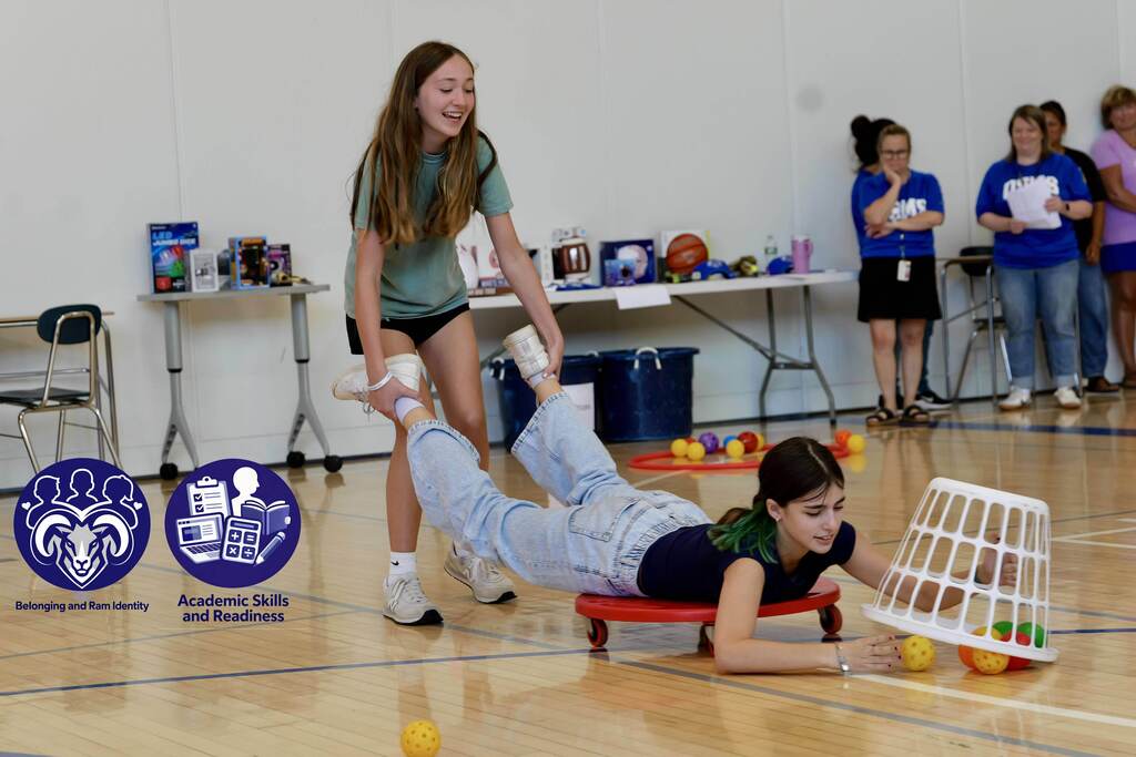 Students take part in a team game during the OSMS Celebration of Learning while staff and classmates look on.