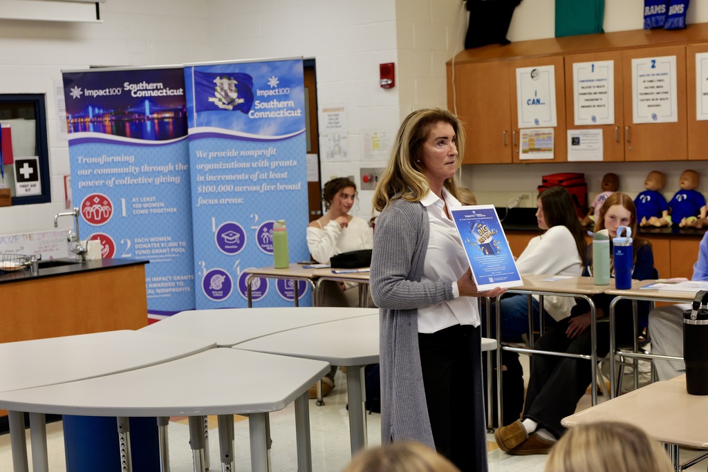 Impact100 President presenting to students