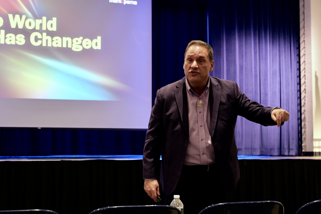 Mark Perna speaking to an audience
