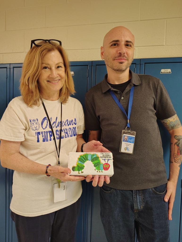 Students with the talented artists who painted book bricks for our Pollinator Rain Garden fundraiser.