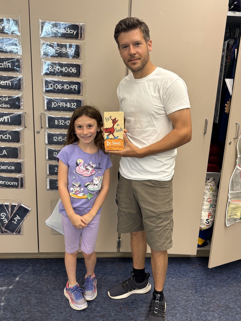 Students with the talented artists who painted book bricks for our Pollinator Rain Garden fundraiser.