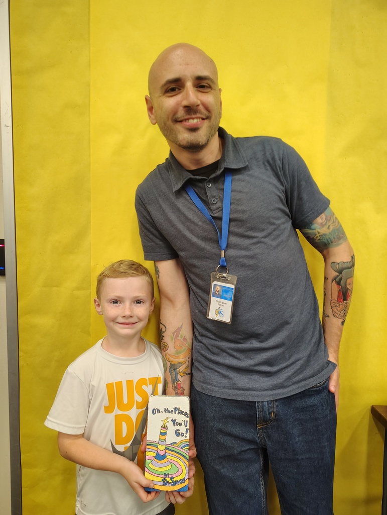 Students with the talented artists who painted book bricks for our Pollinator Rain Garden fundraiser.