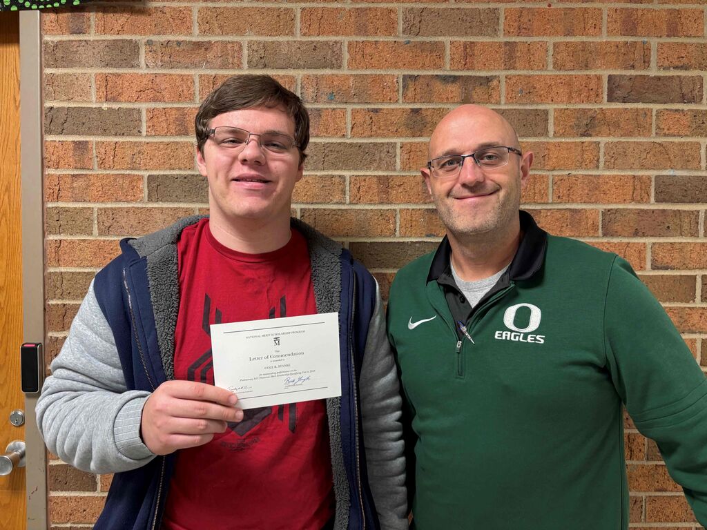 Cole and Mr. Yarbrough with National Merit Certificate