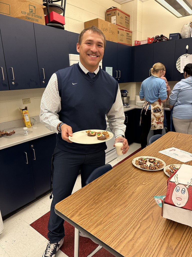 Mr. Flores enjoying the cookies and milk.