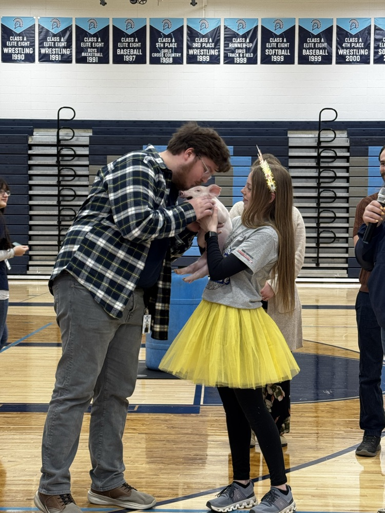 Student teacher kissing the pig!