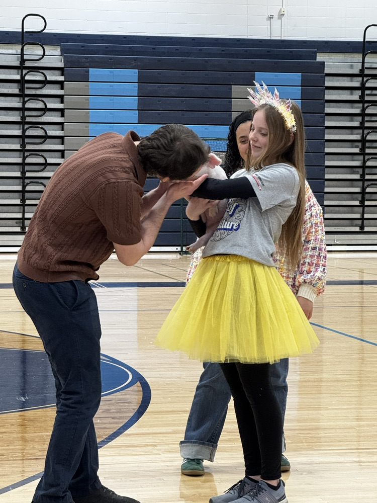 Student teacher kissing the pig!