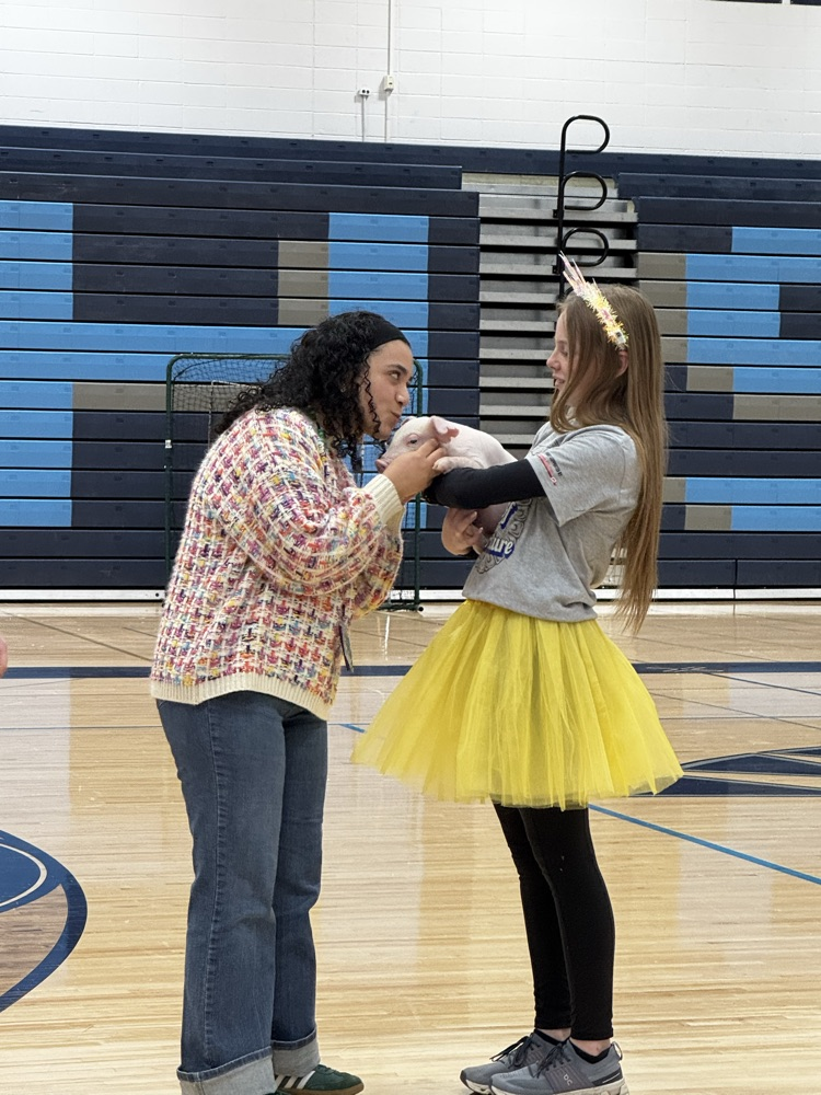 Student teacher kissing the pig!