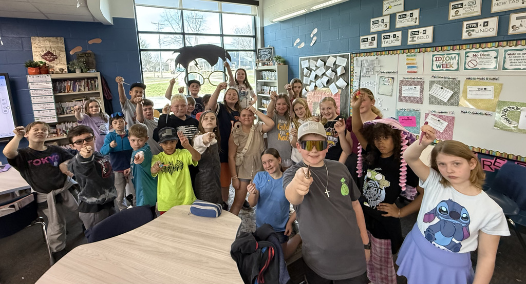 Fifth graders showing off the wands they painted. 