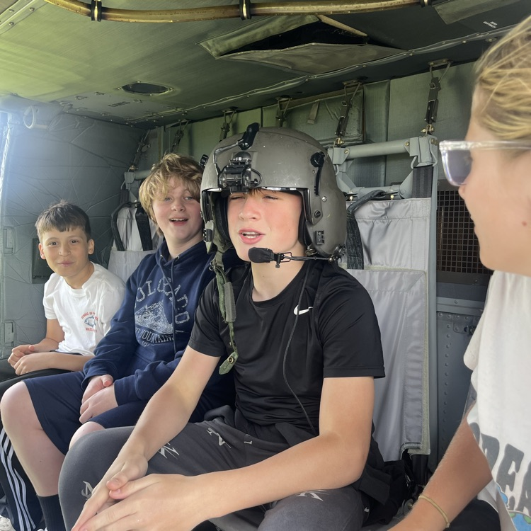 students exploring a helicopter