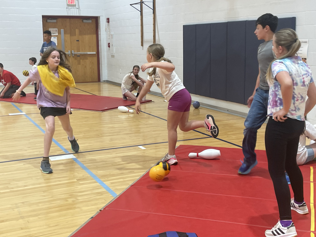 Fifth graders enjoying a variant of traditional dodge ball.