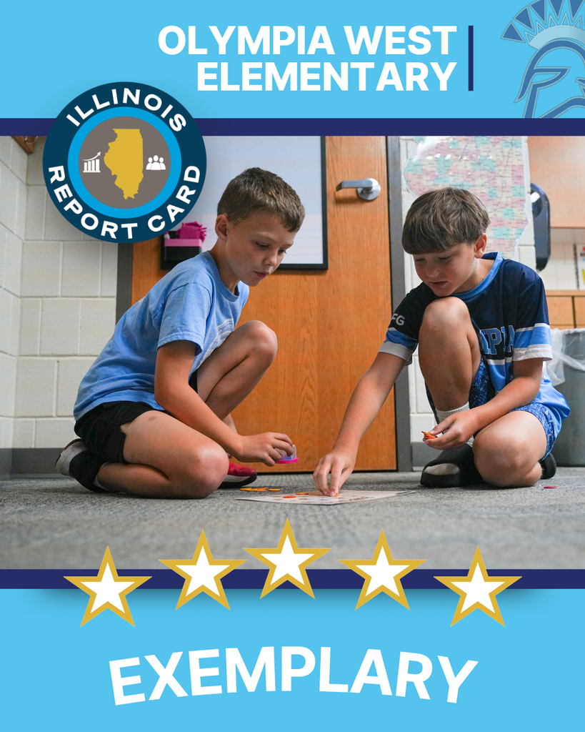 Two male students wearing blue shirts kneeling on the floor