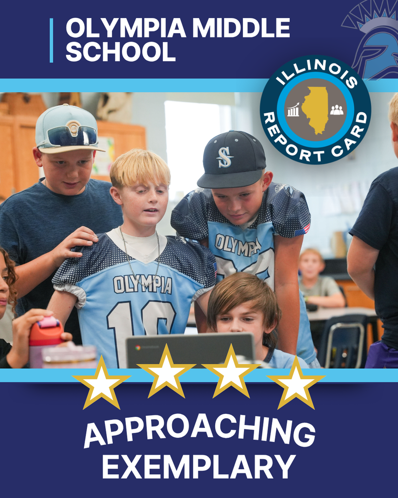 Four male students in blue jerseys looking at a computer screen
