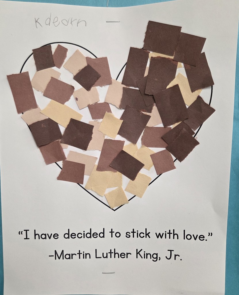 Kindergarteners in Ms. Brown's class at North glue different skin colored squares into a heart to signify peace within diversity.