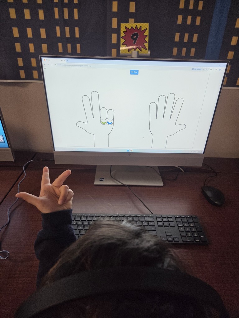 A 1st grade student is using the Edclub typing program to learn finger placement on the keyboard.