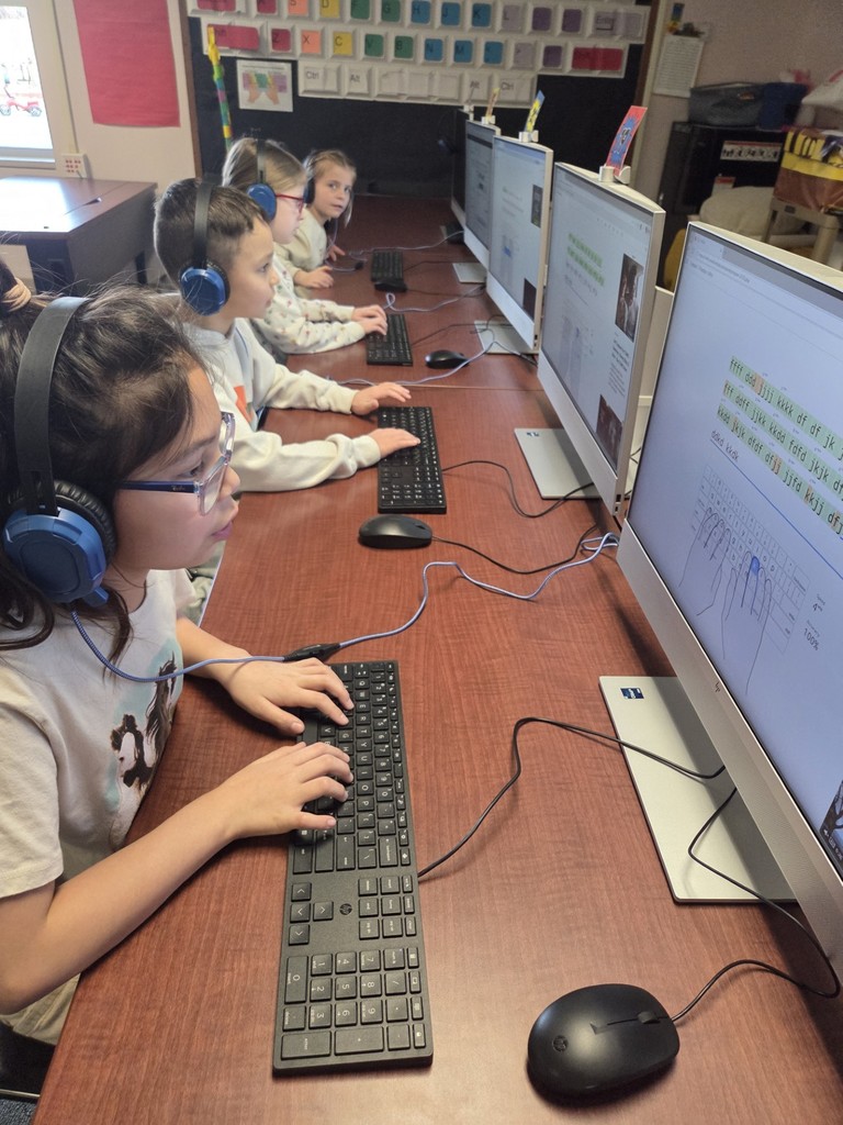 2nd grade students are practicing using correct finger placement and looking at the screen while typing.
