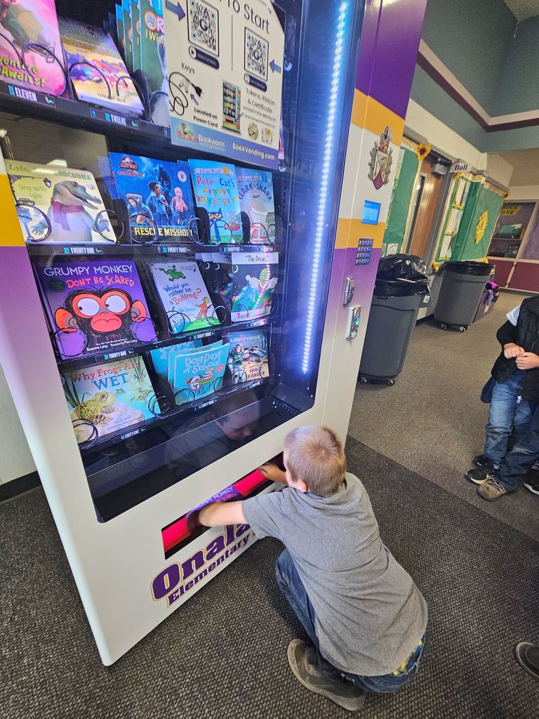 student taking out book