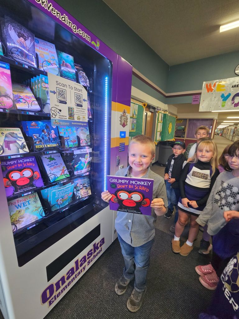 Student excited about book from vending machine