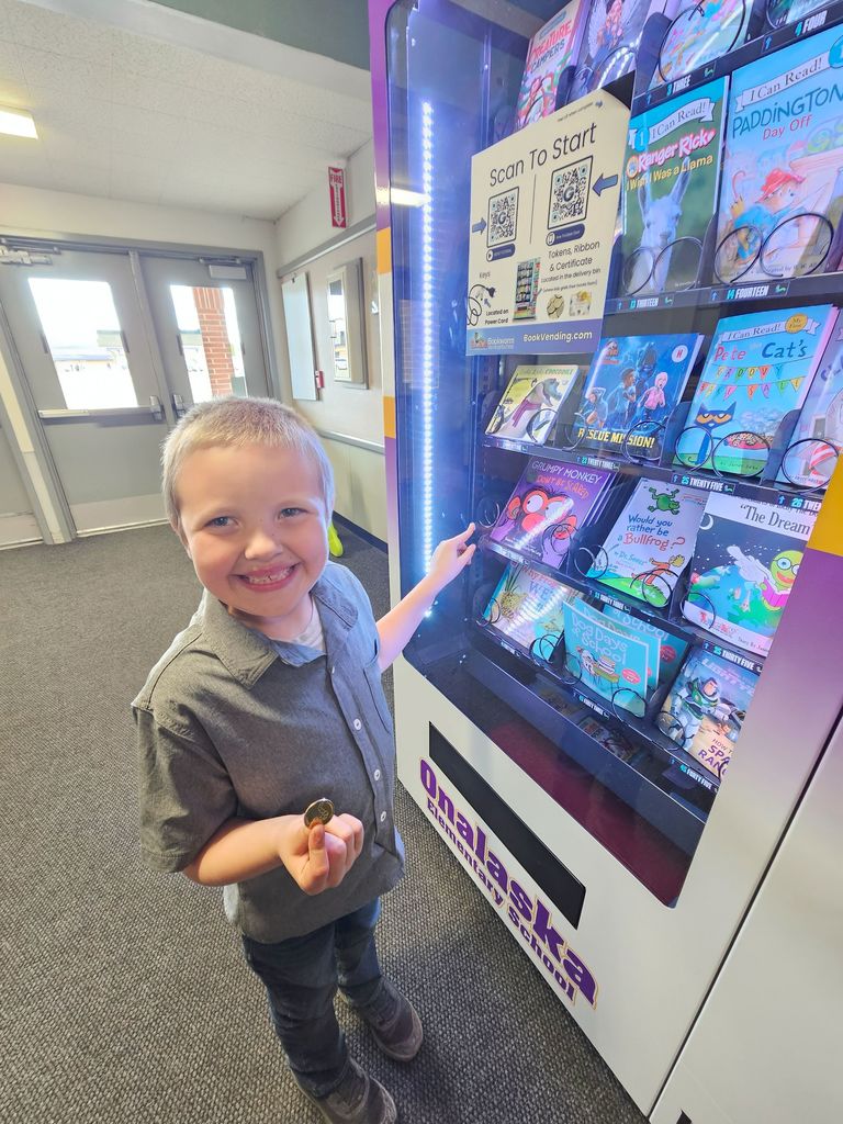 student picking out book