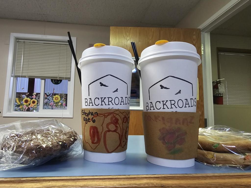 Backroads coffee cups with decorated sleeves and cookies