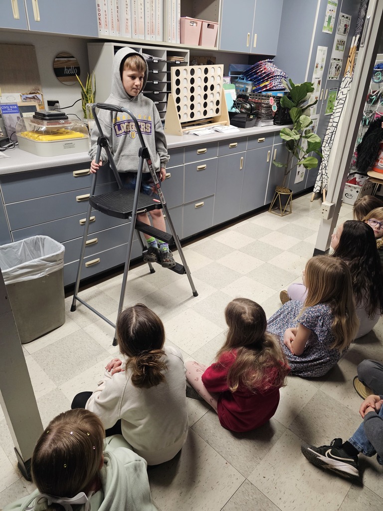 2nd grade students listening to Bubba talk about his incubator