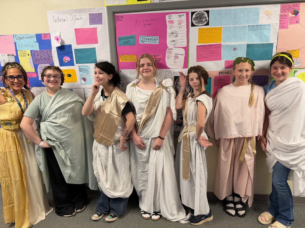 Mrs. Richarson and Middle school students dressed up in togas for Mr. Gerbrach's Greek lesson on 4/17/2026