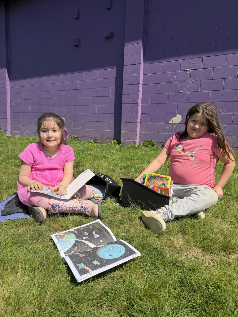 First grade students reading in the sun